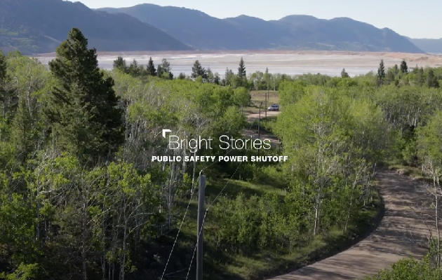 An aerial view of a powerline running through the forest.